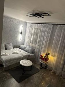 ein kleines Schlafzimmer mit einem Bett und einem Tisch in der Unterkunft Studio Leszczyńskiego Przemyśl in Przemyśl