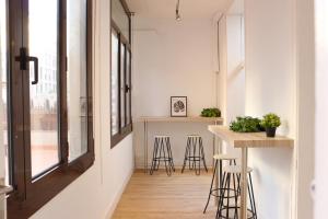 a kitchen with a counter and stools in a room at lullaby by hamilton in Barcelona