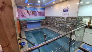a hot tub in a room with a sign on the wall at Wary Nayra Hotel & Spa in Puno