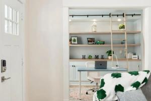 a room with a desk and a table with a laptop at Sweet Retreat 3 Mins to Notre Dame Eddy St Commons and Memorial Hospital in South Bend