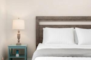 a bedroom with a bed and a table with a lamp at Sweet Retreat 3 Mins to Notre Dame Eddy St Commons and Memorial Hospital in South Bend