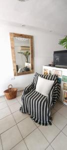 a room with a pillow on a tiled floor with a mirror at Casa Rio in Cruz del Eje