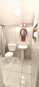 a small bathroom with a toilet and a sink at Casa Rio in Cruz del Eje +12 photos