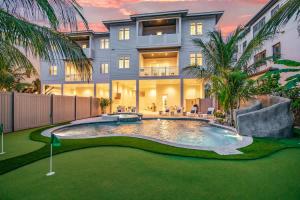 a house with a pool and a golf course in front at Gulfside Green Estate in Siesta Key