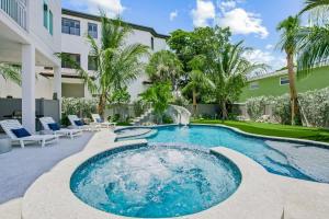 a swimming pool with chairs and a building at Gulfside Green Estate in Siesta Key
