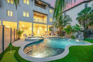 a swimming pool in front of a building at Gulfside Green Estate in Siesta Key