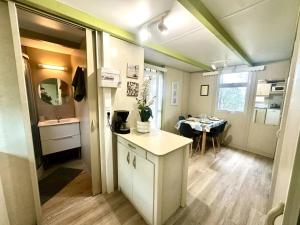 a kitchen and dining area of an rv at ZEcamping 3 étoiles animaux acceptés in Sartène