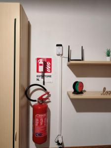 a red fire hydrant is hanging from a shelf at Casa PALLINA FIDENZA in Fidenza