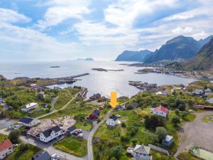 an aerial view of a small town next to a body of water at Littahuset in Moskenes +22 photos