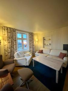 a living room with two white couches and a window at Littahuset in Moskenes