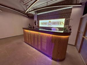 a bar in a room with a man standing behind it at Ikonic Hotel - Bhushi Dam Lonavala in Lonavala +90 photos