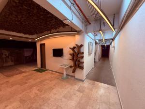 a room with a table in the middle of a building at Ikonic Hotel - Bhushi Dam Lonavala in Lonavala