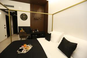 a hotel room with a bed with a tray of food on it at Il Moro Luxury Rooms in Siracusa +127 photos