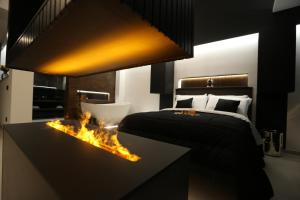 a bedroom with a bed and a fireplace in the middle at B&B Il Moro Luxury Rooms in Syracuse