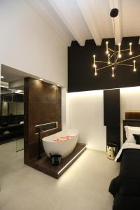 a bathroom with a large bath tub in a room at Il Moro Luxury Rooms in Siracusa