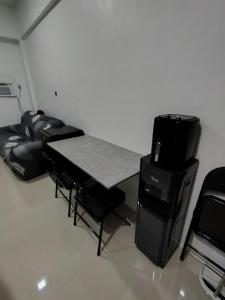 a small room with a table and a couch at Central City Condo Getaway in Gun-ob