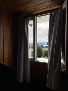 a window with a view of a mountain at Surprise in San Carlos de Bariloche +31 photos