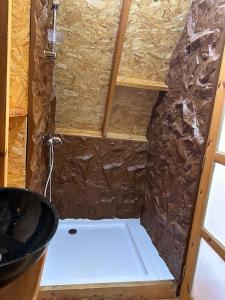 a shower in a room with a stone wall at Elhamma Resort Studio in Tozeur +45 photos