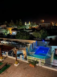 Una piscina de noche con coches aparcados en un aparcamiento. en Toneles - Cafayate, en Cafayate