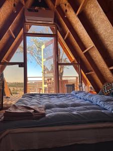 a large bed in a room with a window at Elhamma Resort Studio in Tozeur