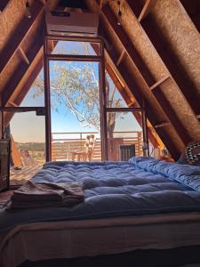 a large bed in a room with a large window at Elhamma Resort Studio in Tozeur