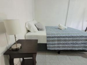 a bedroom with a bed with a teddy bear on it at Mi pueblo Hostal Nahuizalco in Nahuizalco