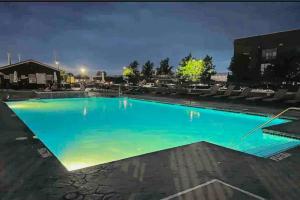 a large swimming pool at night at Mario Room Waterfront Downtown View Cedar Point! in Sandusky