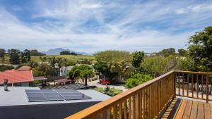 a deck with solar panels on the roof at Hideaway in Herolds Bay