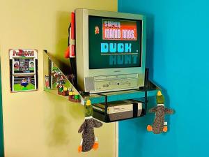a tv on a shelf with a video game on it at Radical 80's Getaway! A Blast From The Past! in Sandusky +67 photos