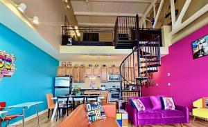 a living room with a purple couch and a kitchen at Radical 80's Getaway! A Blast From The Past! in Sandusky