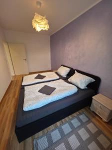 a bedroom with a bed with two pillows on it at Ruhiges Apartment Leipziger Neuseenland, direkte S-Bahn Anbindung Leipzig sowie Messe in Neukieritzsch +6 photos