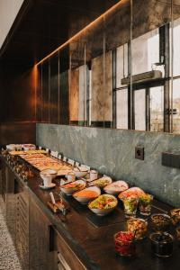 a buffet line with many plates of food at The Cyrus Hotel in Wrocław +111 photos