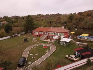 a large red house with cars parked in front of it at Къща за гости сБолярци in Bolyartsi