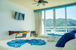 Кровать или кровати в номере Hotel Bahia Taganga +88 фотографий