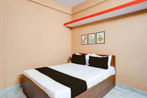 1 dormitorio con 1 cama grande con sábanas blancas y negras en Hotel O Bidadi Railway Junction Bangalore Formerly Ejalla, en Bidadi