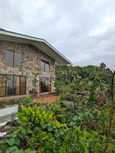 a stone house with a garden in front of it at Villa Piedra Viva in Tilarán