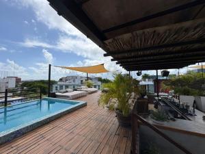 a balcony with a swimming pool on top of a building at Be Playa Hotel Boutique & Rooftop Bar - Adults Only in Playa del Carmen