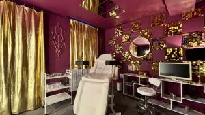 a purple room with a chair and a mirror at Designer Fantasy Den Boutique Seafront in Brighton & Hove +24 photos