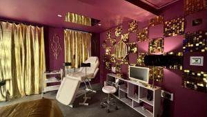 a purple room with a chair and a mirror at Designer Fantasy Den Boutique Seafront in Brighton & Hove
