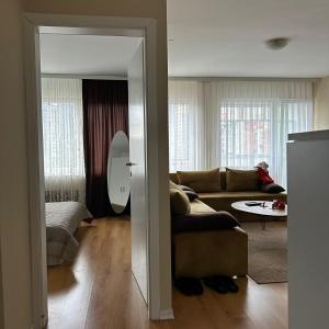 a living room with a couch and a table at Apartment in Prishtina, Kosovo in Pristina +5 photos