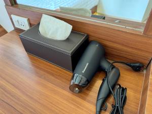 a black hair dryer and a box on a counter at Sonata siam-ratchathewi in Bangkok