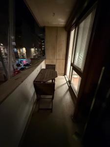 a table and a chair in a room with a window at Trocadero in Paris +12 photos