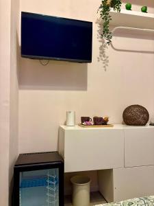 Una televisión o centro de entretenimiento en "Private Room" stanza privata with private bathroom - shared kitchen and beautiful terrace on Taormina Center Hostel Taormina