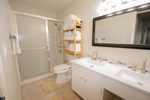 a bathroom with a toilet and a sink and a mirror at Charming Lafayette Condo Cozy Retreat in Indiana in Lafayette +8 photos