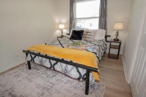 a bedroom with a bed with a yellow blanket on it at Charming Lafayette Condo Cozy Retreat in Indiana in Lafayette