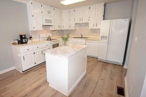 a kitchen with white cabinets and a white refrigerator at Charming Lafayette Condo Cozy Retreat in Indiana in Lafayette