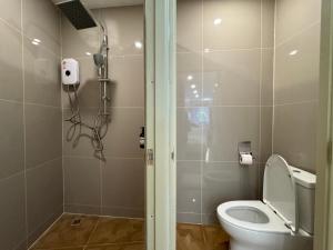 a bathroom with a toilet and a shower in it at Sonata siam-ratchathewi in Bangkok +16 photos