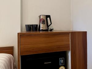 a coffeemaker sitting on top of a wooden table at Sonata siam-ratchathewi in Bangkok