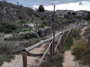 a wooden fence on the side of a mountain at By Domy 2 Grottaglie in Grottaglie