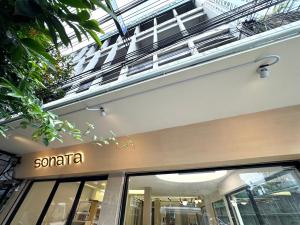 a santa sign on the side of a building at Sonata siam-ratchathewi in Bangkok
